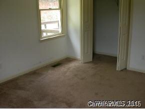 1942 Coopers Gap Road Mill Spring, NC 28756 - Photo 7 of 12 a view of an empty room with a window