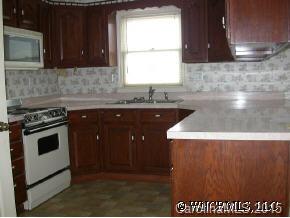 1942 Coopers Gap Road Mill Spring, NC 28756 - Photo 10 of 12 a kitchen with a sink a stove and cabinets