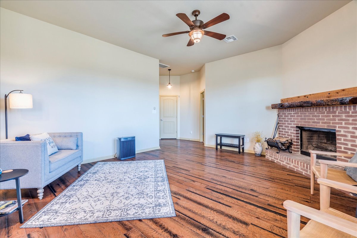 909 County Road 342 Granger, TX 76530 - Photo 14 of 37 Family room with wood burning fireplace and wall of windows