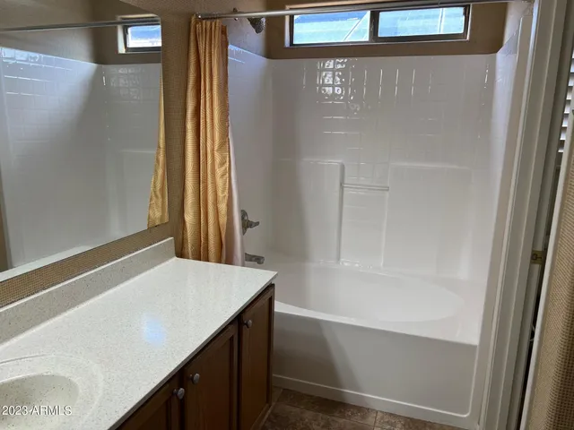 a bathroom with a tub and shower