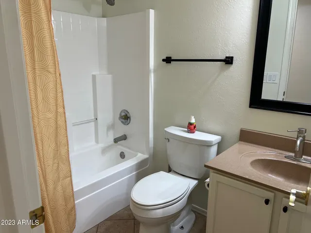a white toilet sitting next to a bath tub