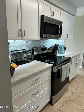 a large white kitchen with cabinets