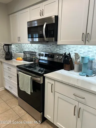 a kitchen with stainless steel appliances a refrigerator sink and window
