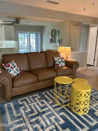 a living room with a washing machine and a stove