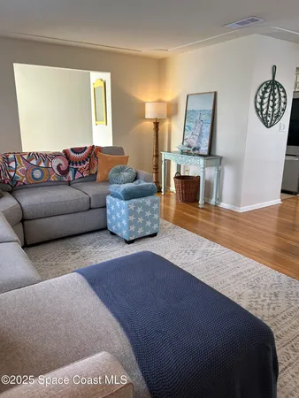 a dining room with furniture window and wooden floor