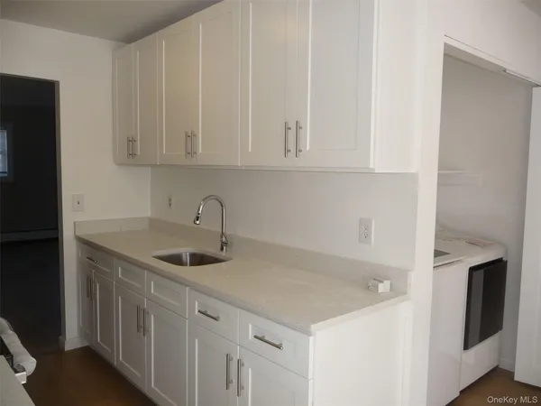 a utility room with cabinets washer and dryer