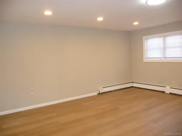 a white toilet sitting next to a white wall