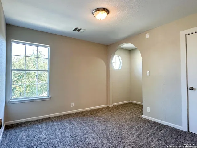 an empty room with windows and closet