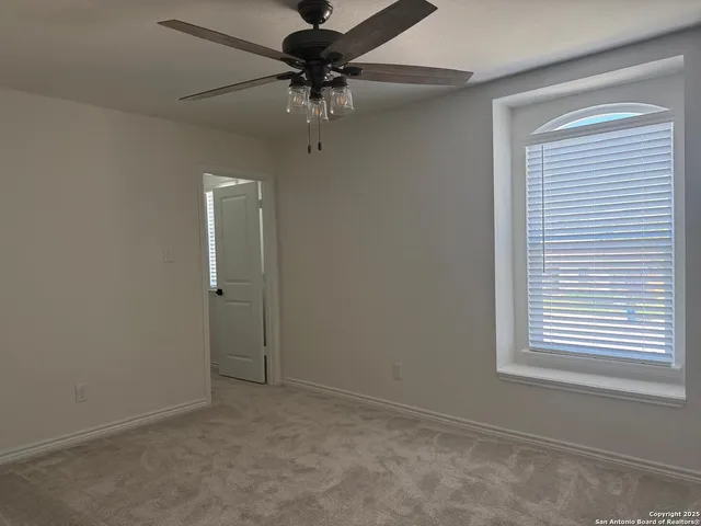 a workspace with chandelier and window