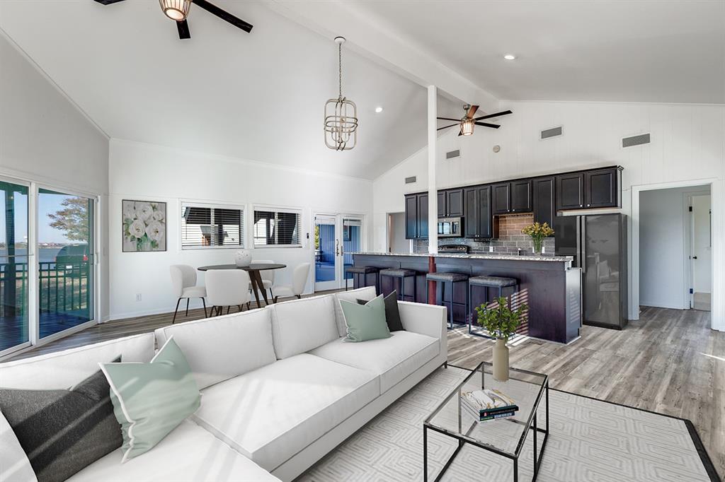 a living room with furniture and kitchen view