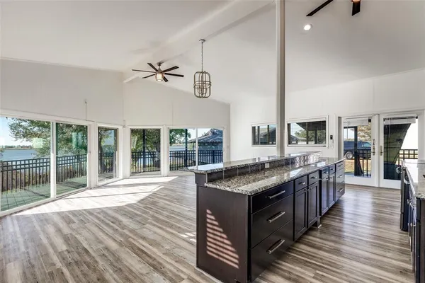 a kitchen with stainless steel appliances granite countertop a stove and a wooden floors
