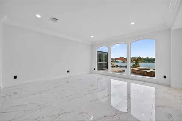 a large kitchen with stainless steel appliances kitchen island granite countertop a refrigerator and a sink