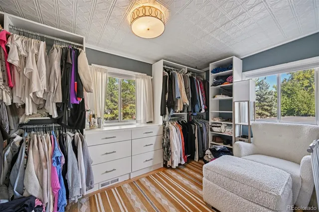 a bathroom with a granite countertop sink a mirror and shower