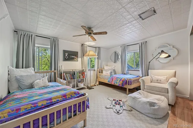 a view of a bedroom with wooden floor and furniture