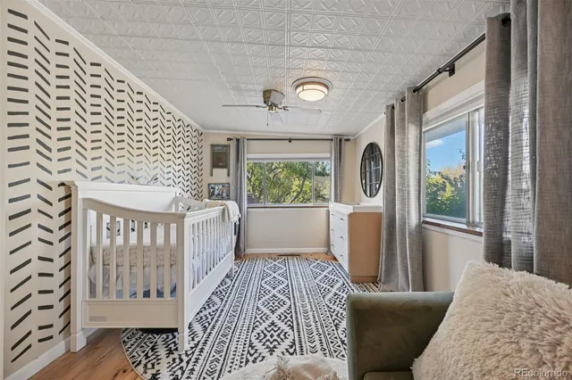 a living room with patio furniture and a rug