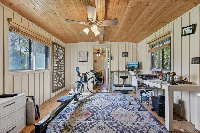 a view of a pathway of a house with potted plants and a large window