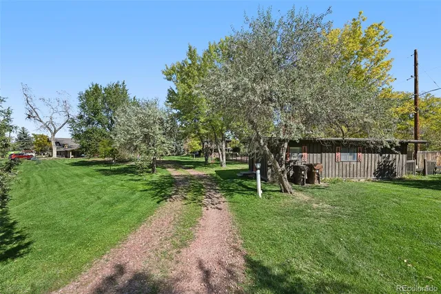a living room with furniture a fireplace and a large window