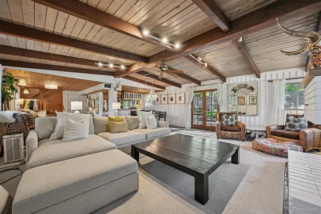 a view of a dining room with furniture and a chandelier