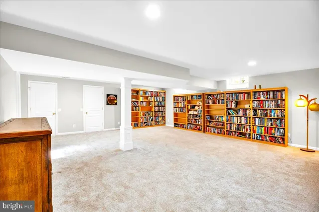 a view of an empty room with a window and storage