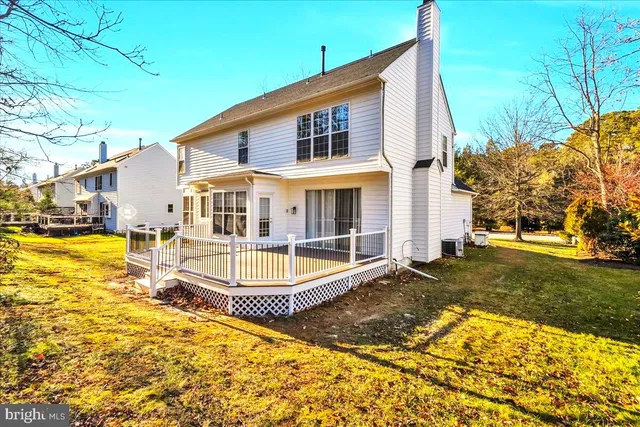 a view of a house with pool and sitting area