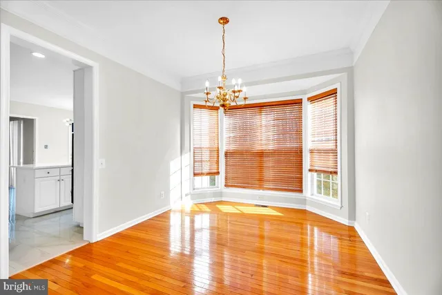a view of a room with wooden floor and a large window