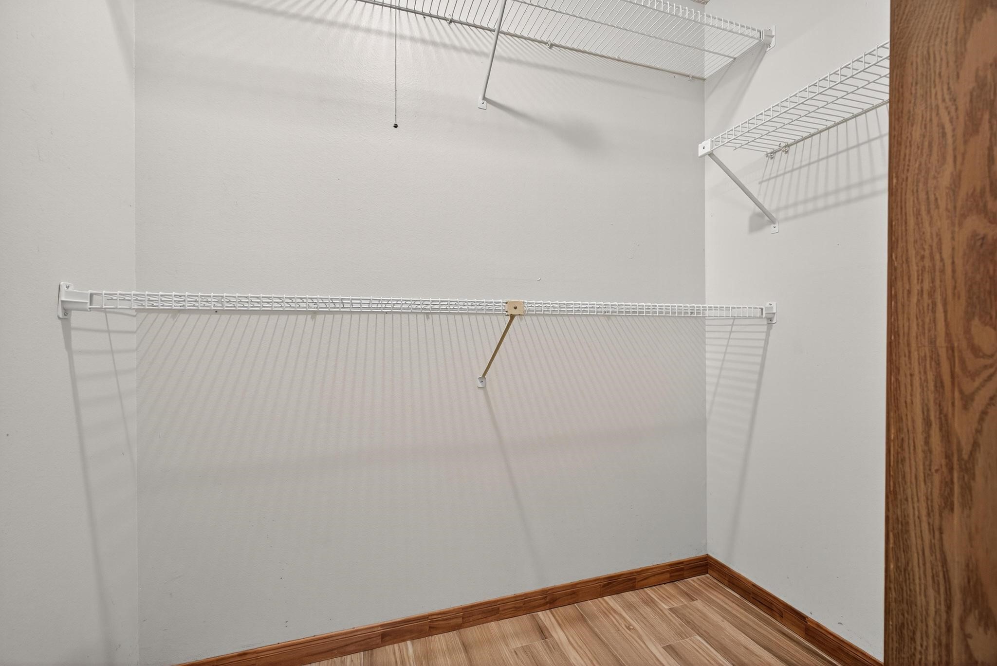 11803 Inga Lane Houston, TX 77064 - Photo 28 of 39 Discover ample organization with this spacious closet featuring sleek white wire shelving, perfect for maximizing storage in style.