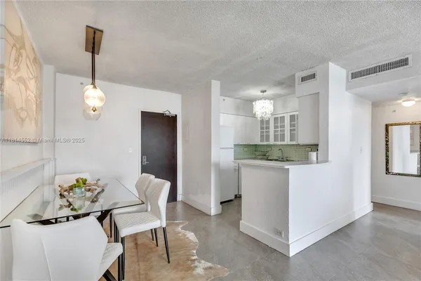 a view of dining room and kitchen with furniture
