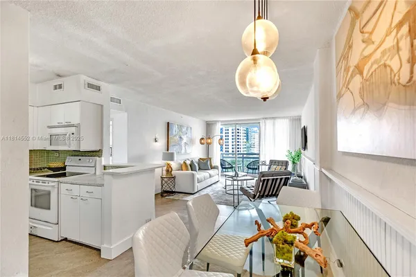 a very nice looking living room with dining room furniture