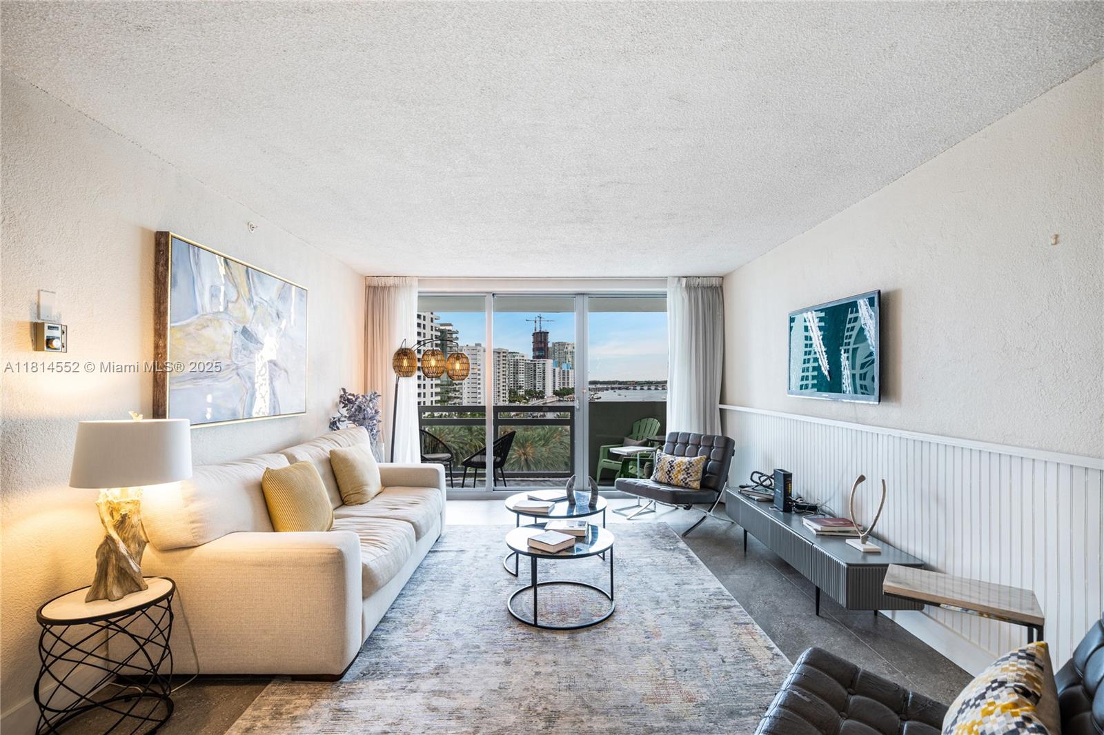 1500 Bay Road, Unit 830S Miami Beach, FL 33139 - Photo 3 of 20 a living room with furniture and white walls