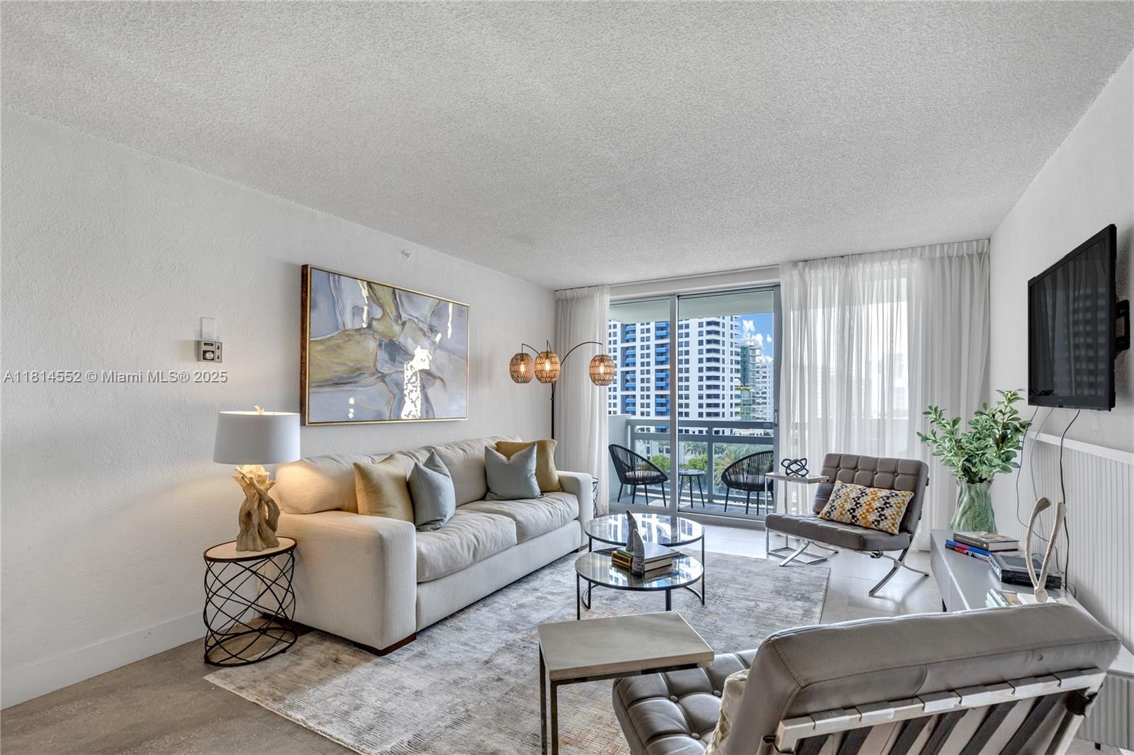 1500 Bay Road, Unit 830S Miami Beach, FL 33139 - Photo 7 of 20 a living room with furniture and a large window
