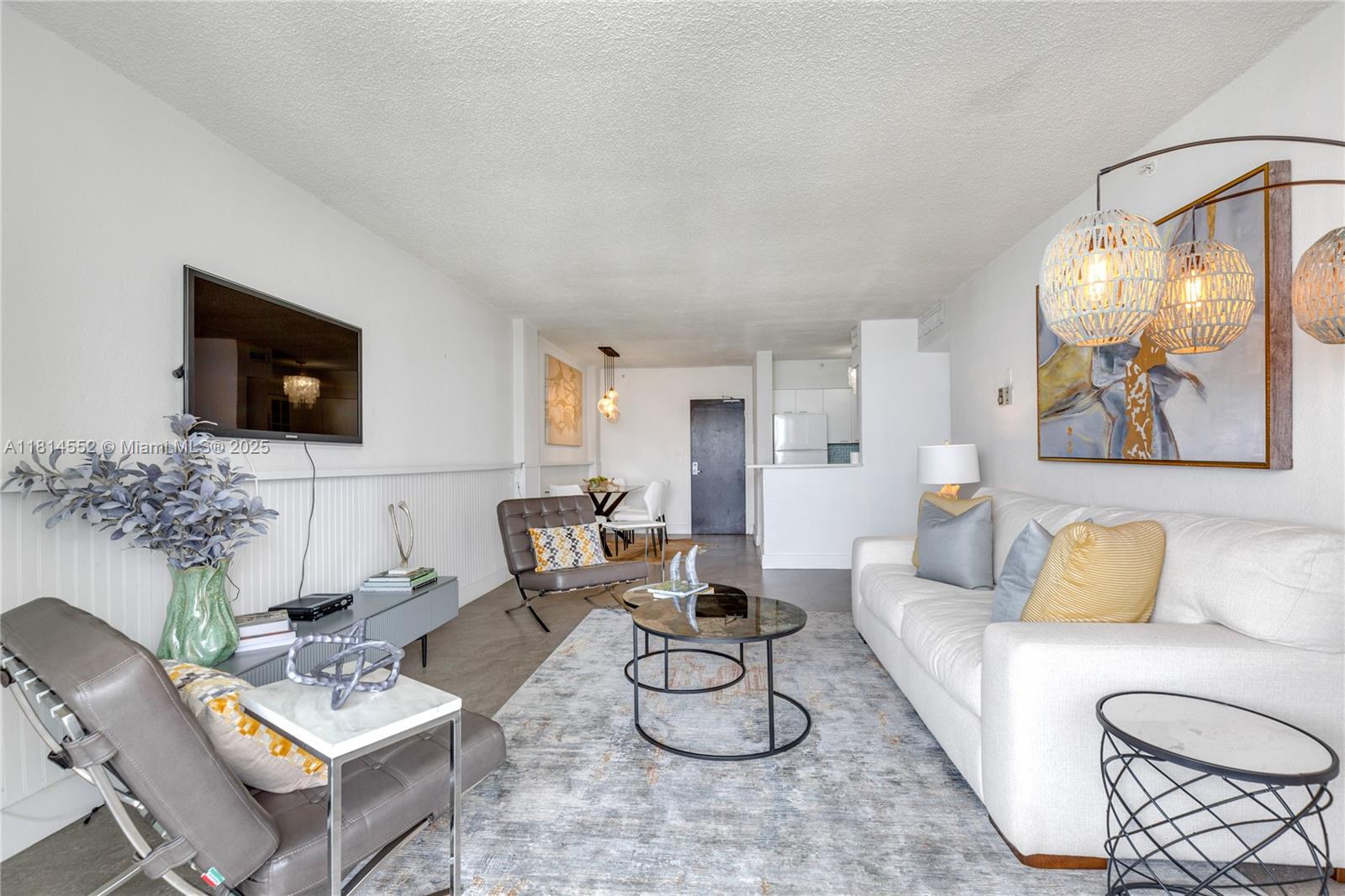 1500 Bay Road, Unit 830S Miami Beach, FL 33139 - Photo 8 of 20 a living room with furniture and a flat screen tv