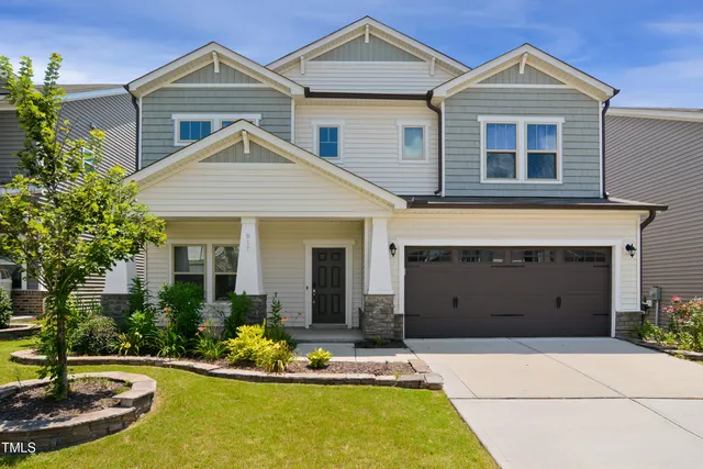 a front view of a house with a yard and garage