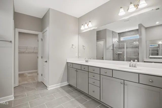 a bathroom with a double vanity sink mirror and double
