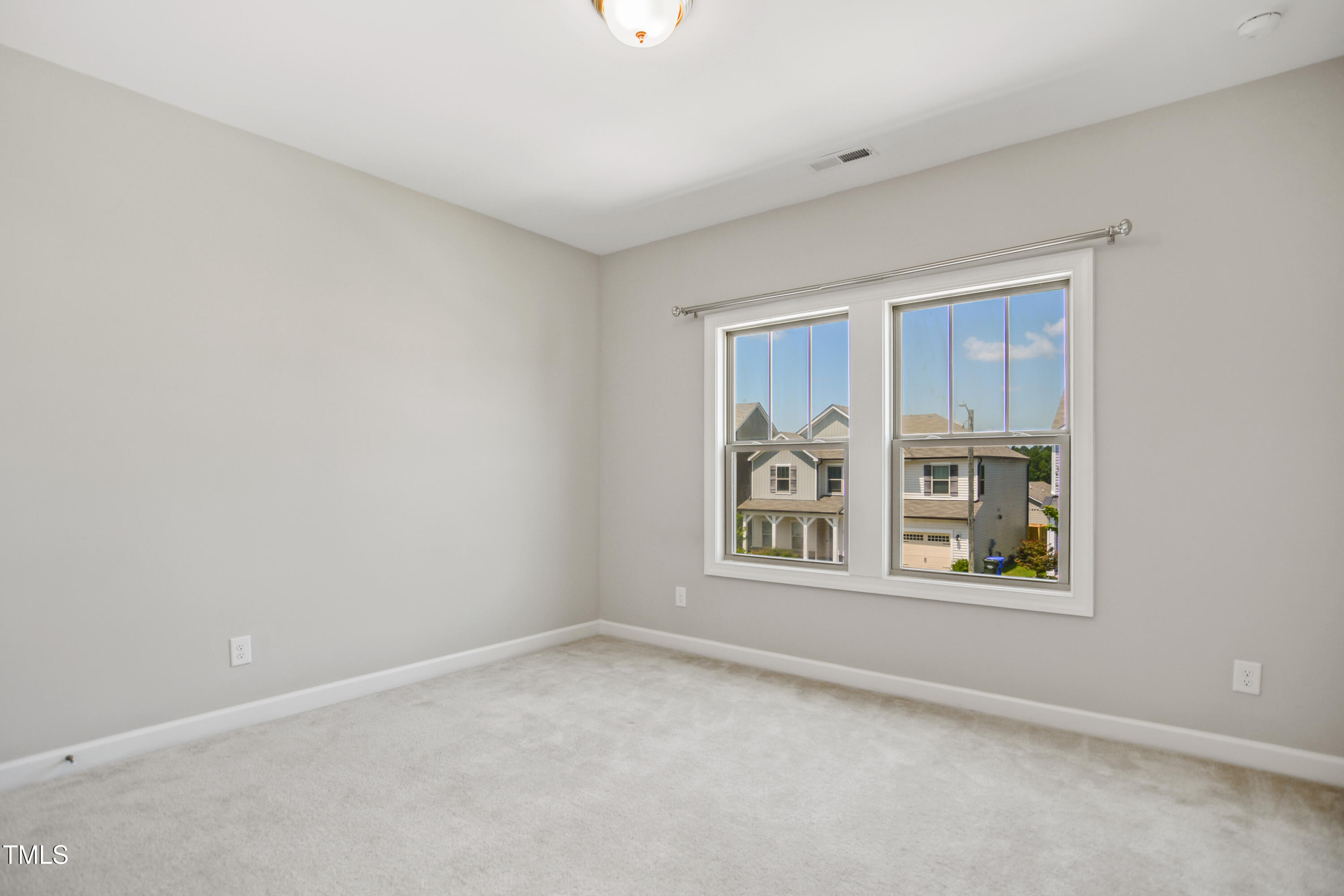 917 Lippincott Road Durham, NC 27703 - Photo 22 of 30 an empty room with windows and closet