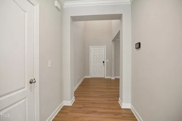 a view of a hallway with wooden floor