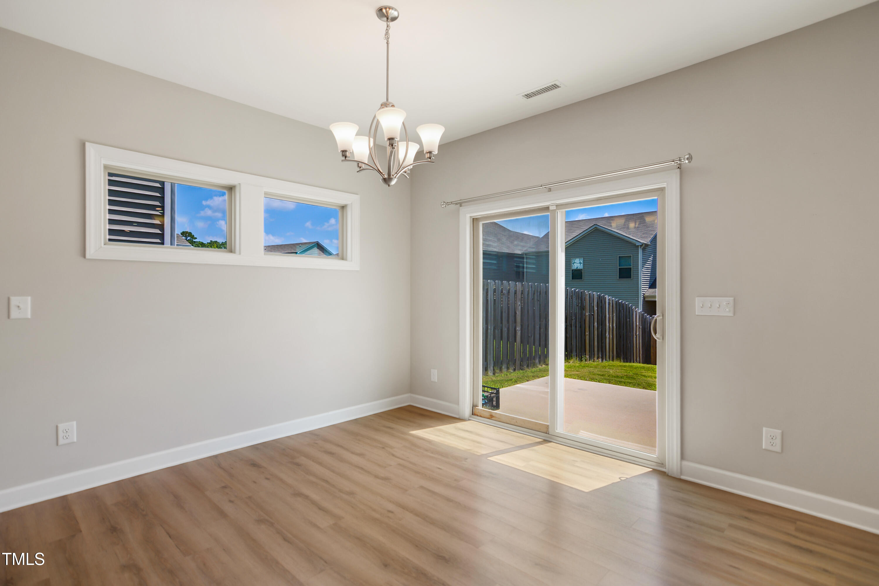 917 Lippincott Road Durham, NC 27703 - Photo 10 of 30 a view of an empty room with window and wooden floor