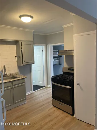 a kitchen with granite countertop a stove and a refrigerator