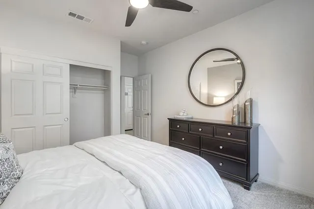 a bedroom with a bed and a dresser