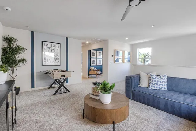 a living room with furniture and a potted plant