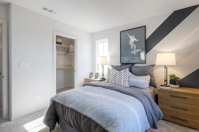 a bedroom with a bed and a mirror