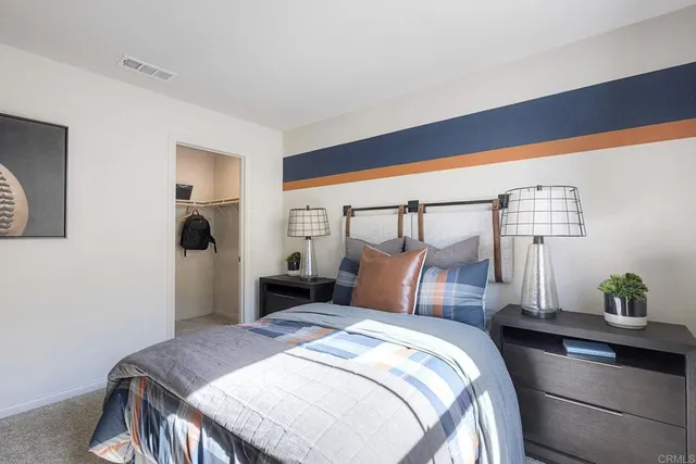 a bedroom with a bed and a potted plant