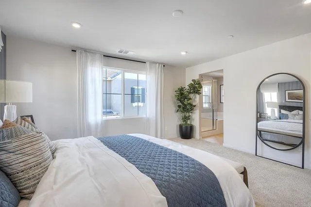 a bedroom with a large bed and a large window