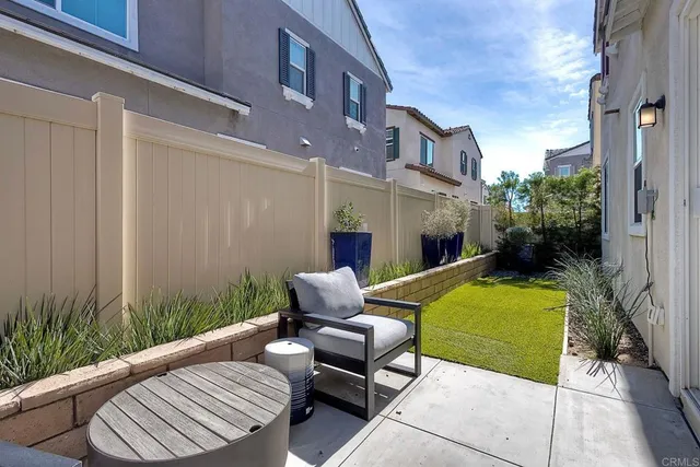 a view of a patio with couches chairs and a potted plant