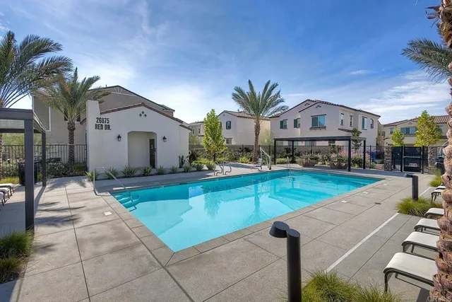 a view of a house with swimming pool and sitting area