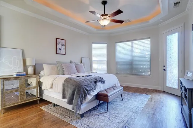 a spacious bedroom with a large bed and a chandelier
