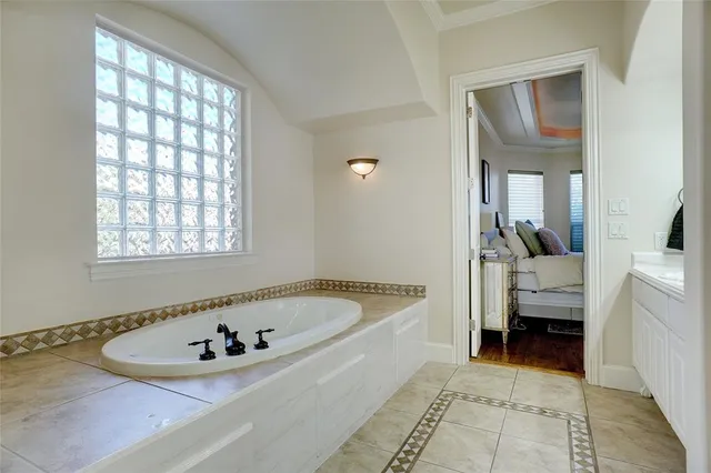 a bath room with a bath tub and a mirror