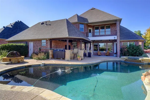 a view of a patio with couches table and chairs with potted plants