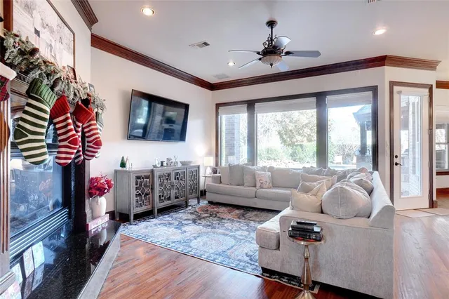 a living room with furniture fireplace and flat screen tv