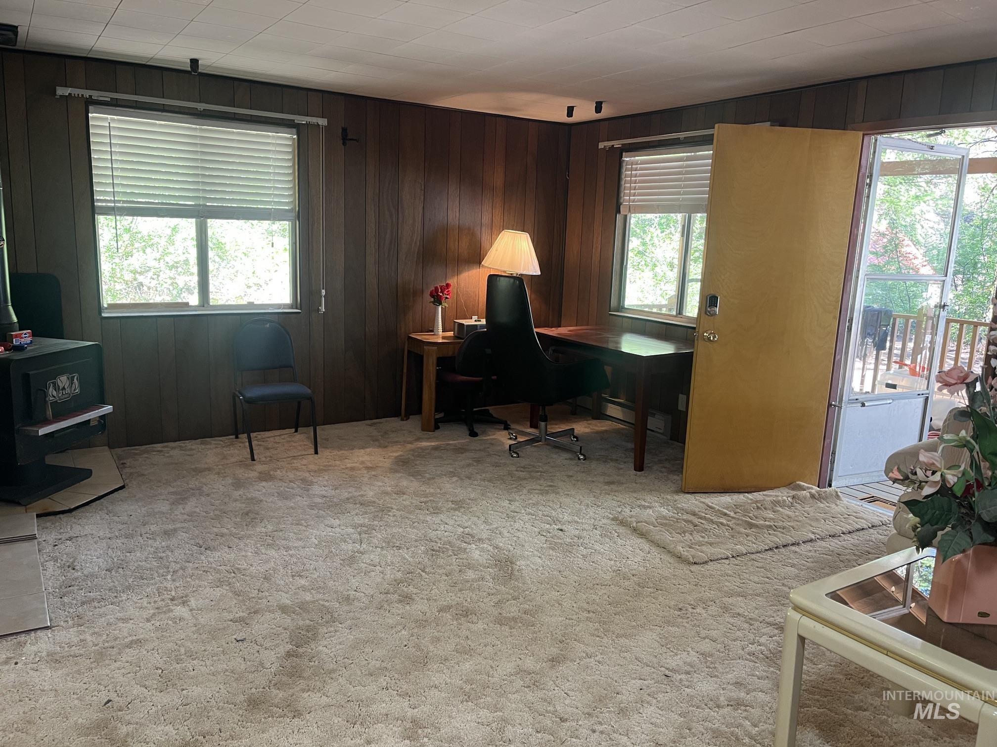 39 Mayflower Mine Road Placerville, ID 83666 - Photo 19 of 36 Spacious interior room featuring wood paneling, multiple windows, and track lighting