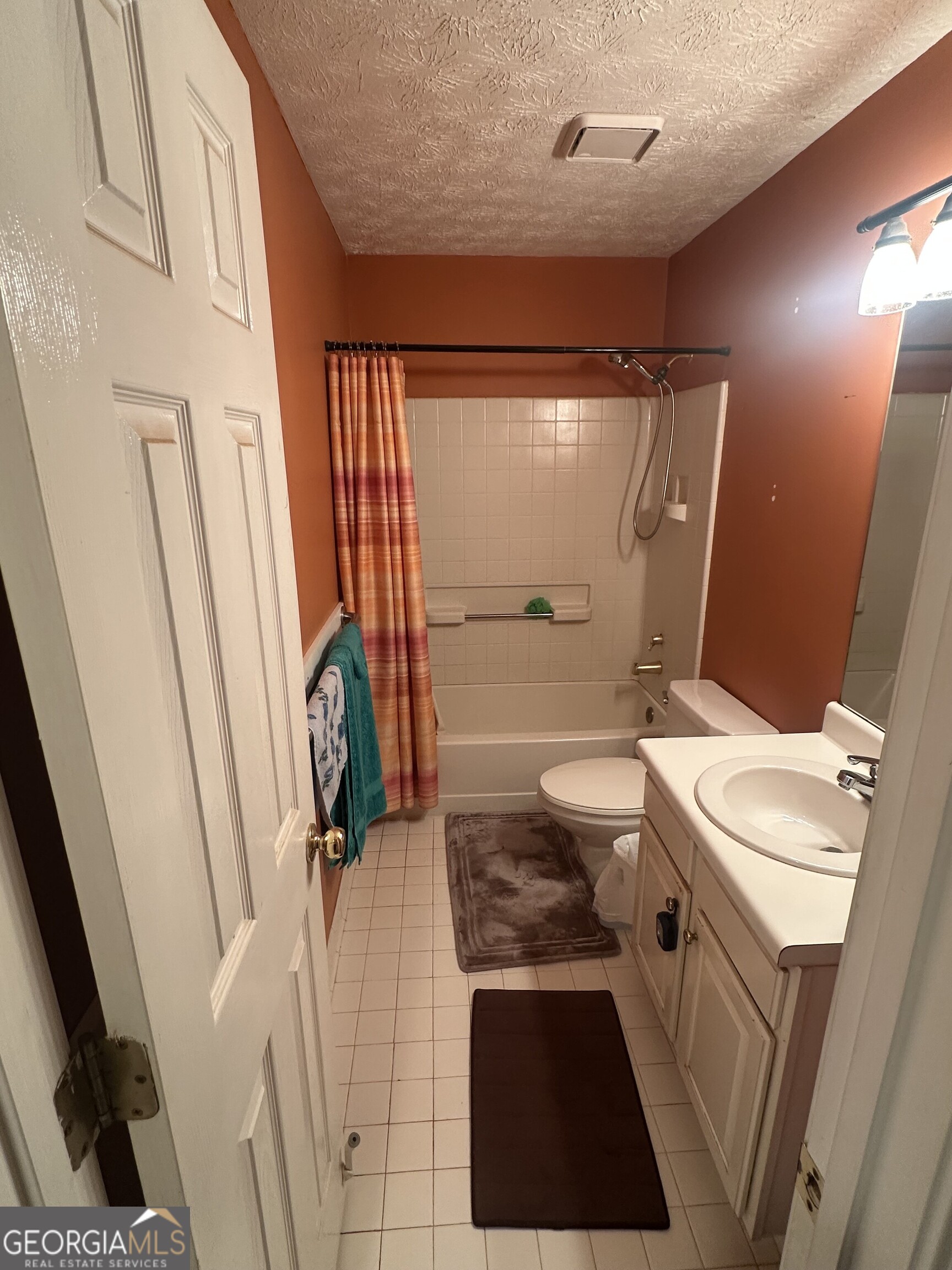 565 Patillo Road Stockbridge, GA 30281 - Photo 12 of 31 a bathroom with a sink a toilet a mirror and shower